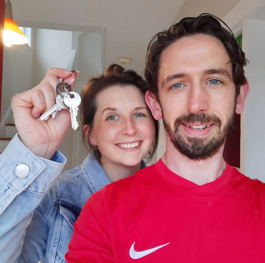 Happy couple holding keys to new home